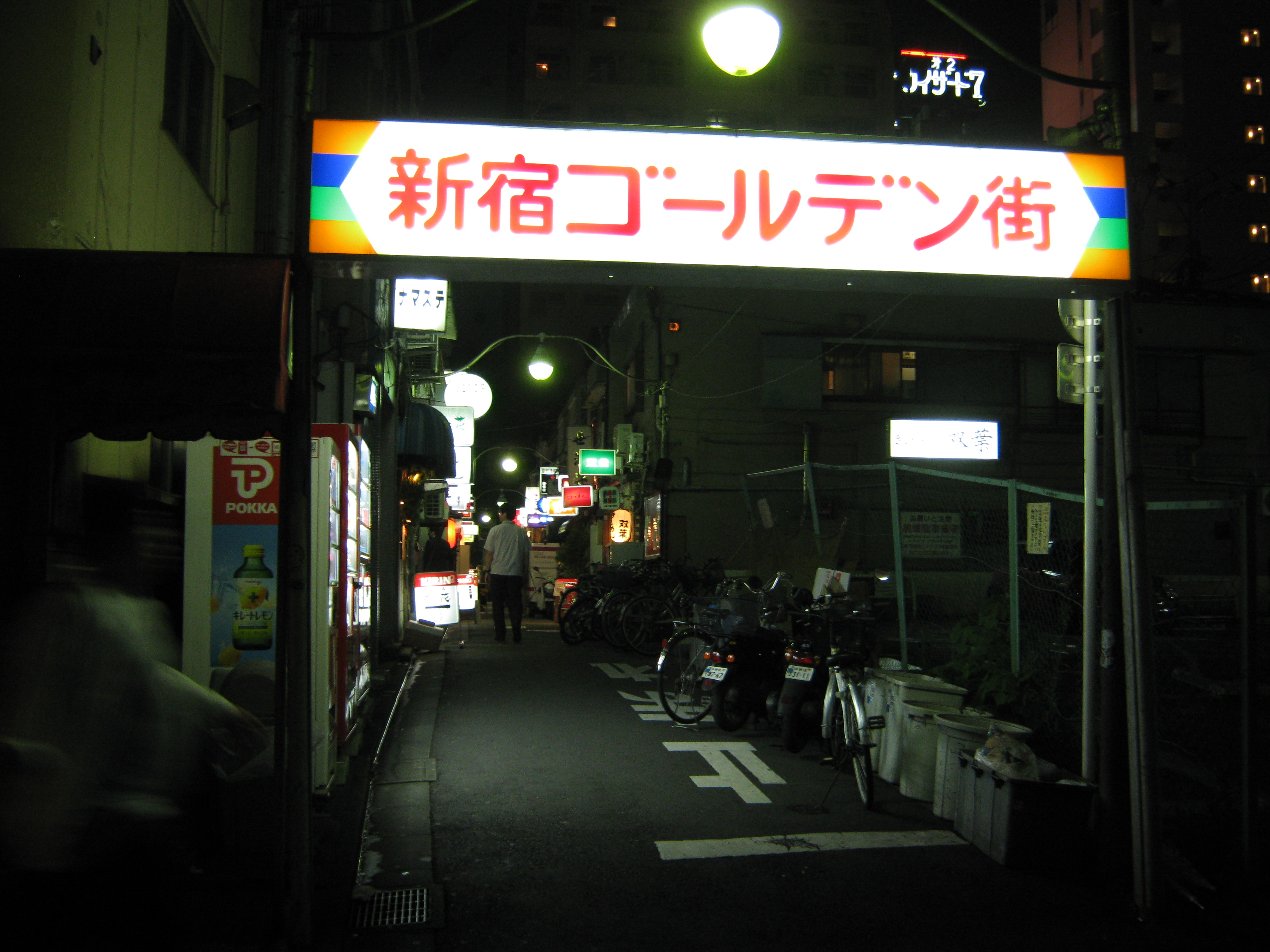 Golden Gai alley at night with tiny bar doors